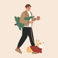 Happy guy in outerwear with corgi dog go and carry christmas tree, prepare to celebrate Xmas and New Year